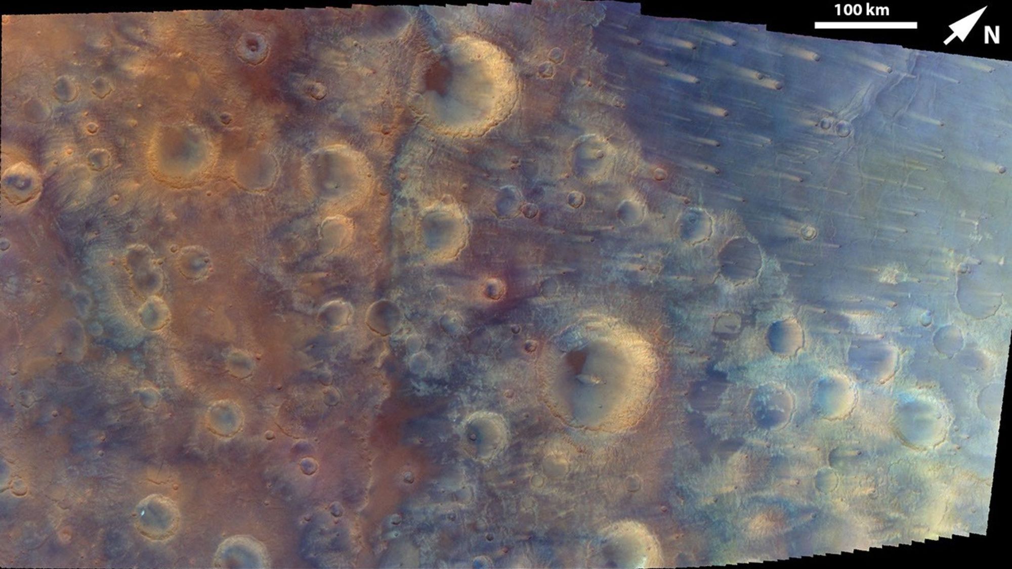 A slightly blurry view of a cratered surface