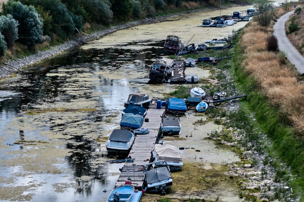 Boats are stranded in a side arm of the river Rhine that is running out of water in Mackenheim near Mainz, Germany Monday