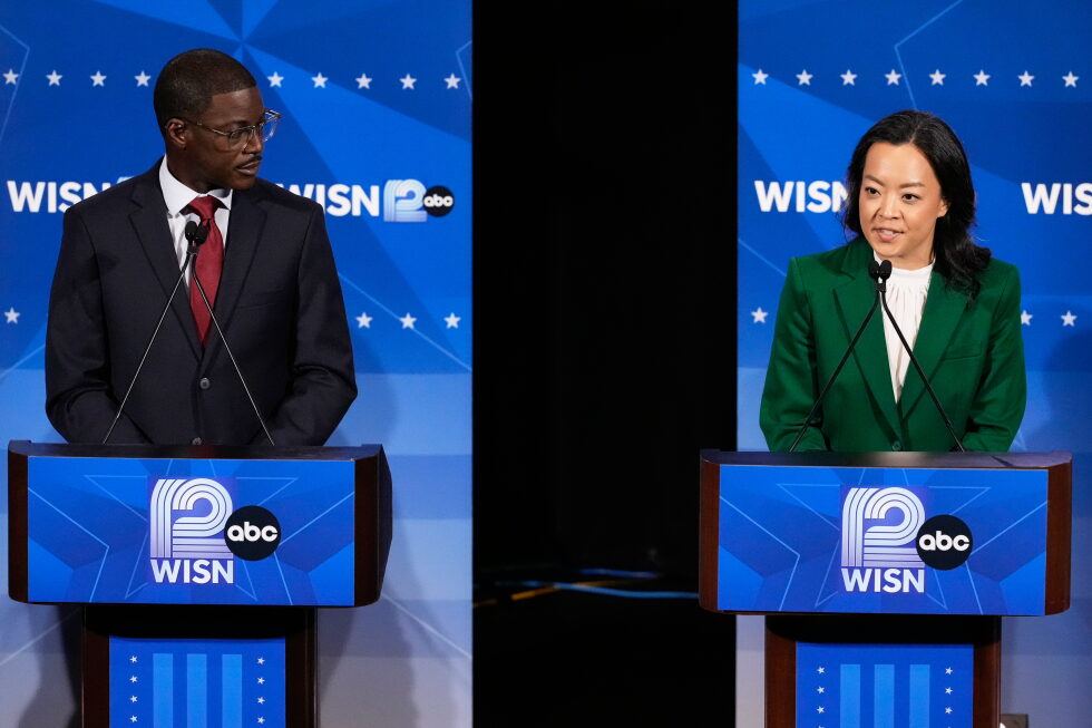 Democratic gubernatorial candidate Francesca Hong, right, talks as David Crowley listens during a primary debate in