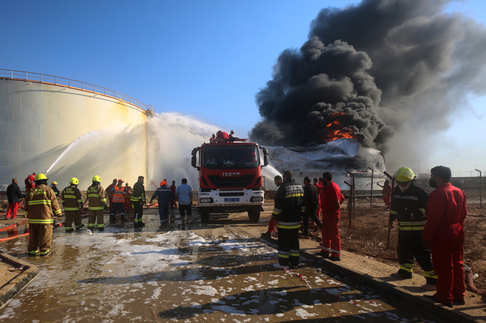 Firefighters work to contain a fire at the Zawiya oil refinery following a drone strike in Zawiya, Libya, Tuesday, Aug. 11