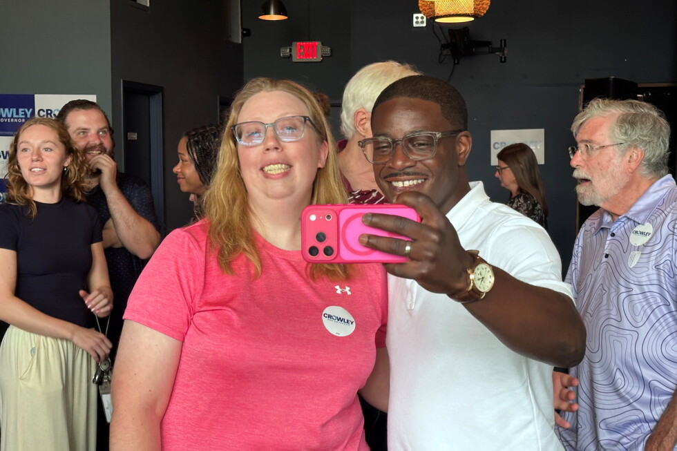 David Crowley, Democratic candidate for Wisconsin governor, takes a selfie photo with supporter Abigail Tessmann during a